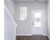 Bright entryway with wood-look floors, staircase, and a sidelight window near the front door at 2122 Willow Gln Dr, Graham, NC 27253