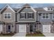 Charming two-story townhome with gray siding, brick accents, and a one-car garage at 2122 Willow Gln Dr, Graham, NC 27253