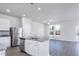 Open-concept kitchen features stainless appliances, granite countertops, and an island with a sink at 2122 Willow Gln Dr, Graham, NC 27253
