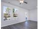 Bright living room with wood-look floors, natural light from windows, and a ceiling fan at 2122 Willow Gln Dr, Graham, NC 27253