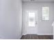 Bright entryway featuring a frosted glass door, light grey walls, and a window for natural light at 2126 Willow Gln Dr, Graham, NC 27253