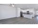 Open concept kitchen with stainless steel appliances, gray wood floors and white cabinets at 2126 Willow Gln Dr, Graham, NC 27253