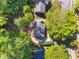 An aerial view reveals mature trees surrounding a home at 216 Burkwood Ln, Raleigh, NC 27609