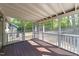 Enclosed back porch with wood flooring and screened walls offers views of the backyard at 216 Burkwood Ln, Raleigh, NC 27609