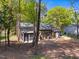 View of a charming home featuring a screened in porch, mature trees, and a detached garage at 216 Burkwood Ln, Raleigh, NC 27609