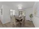 Bright dining room with a stylish light fixture, seating for six, and access to kitchen at 216 Burkwood Ln, Raleigh, NC 27609