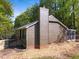 Home's rear elevation with wood siding, dark trim and an enclosed back porch at 216 Burkwood Ln, Raleigh, NC 27609