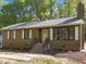 Charming home featuring wood siding, brick foundation and landscaped front yard at 216 Burkwood Ln, Raleigh, NC 27609