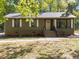 Olive green siding adorns this home, complemented by brick accents and crisp white trim at 216 Burkwood Ln, Raleigh, NC 27609