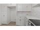 Bright kitchen features white cabinets, quartz countertops, stainless appliances, and modern backsplash at 216 Burkwood Ln, Raleigh, NC 27609