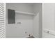 Minimalist laundry room features hookups, shelving, and a modern door at 216 Burkwood Ln, Raleigh, NC 27609