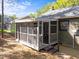 Cozy screened-in porch with wood trim offers a tranquil outdoor living space at 216 Burkwood Ln, Raleigh, NC 27609