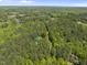 Secluded property nestled among a dense forest with mature trees and a long private driveway at 216 Dairyland Rd, Chapel Hill, NC 27516