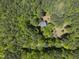 Aerial view of home nestled in a beautiful and lush green forest at 216 Dairyland Rd, Chapel Hill, NC 27516