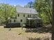 Exterior view of back of home with screened porch and spacious yard at 216 Dairyland Rd, Chapel Hill, NC 27516