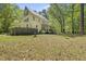 View of the backyard, home's back exterior, with screened porch at 216 Dairyland Rd, Chapel Hill, NC 27516