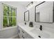 Dual sink bathroom featuring modern mirrors, quartz countertops and matte black fixtures at 216 Dairyland Rd, Chapel Hill, NC 27516