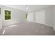 Bright bedroom featuring neutral walls, carpet, and windows with tree views at 216 Dairyland Rd, Chapel Hill, NC 27516