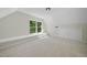 Bright bonus room featuring neutral carpet, ample natural light, and built-in shelving at 216 Dairyland Rd, Chapel Hill, NC 27516