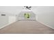 Bright bonus room featuring neutral carpet, ample natural light, and built-in shelving at 216 Dairyland Rd, Chapel Hill, NC 27516