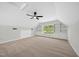 Bright bonus room featuring neutral carpet, ample natural light, and built-in shelving at 216 Dairyland Rd, Chapel Hill, NC 27516
