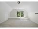 Bright bonus room featuring neutral carpet, ample natural light, and built-in shelving at 216 Dairyland Rd, Chapel Hill, NC 27516