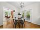 Bright dining room with hardwood floors, modern light fixture, and door to back porch, perfect for entertaining at 216 Dairyland Rd, Chapel Hill, NC 27516