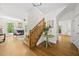 Open foyer with hardwood floors, staircase, and view into the living room with fireplace at 216 Dairyland Rd, Chapel Hill, NC 27516