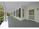 Inviting covered front porch with gray painted flooring and white trim at 216 Dairyland Rd, Chapel Hill, NC 27516