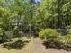 Charming home with lush landscaping, mature trees, and well-manicured lawn at 216 Dairyland Rd, Chapel Hill, NC 27516
