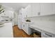 This kitchen features white cabinetry, quartz counters, stainless steel appliances and a built in desk nook at 216 Dairyland Rd, Chapel Hill, NC 27516
