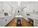 Modern kitchen with white cabinets, quartz countertops, stainless appliances, and hardwood floors, great for cooking at 216 Dairyland Rd, Chapel Hill, NC 27516