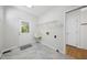 Neutral laundry room with utility sink, tile floors and exterior access at 216 Dairyland Rd, Chapel Hill, NC 27516