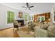 Bright and spacious living room featuring a cozy fireplace, large windows, and hardwood floors at 216 Dairyland Rd, Chapel Hill, NC 27516