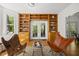 Bright sitting room with built-in bookshelves, French doors, and comfortable seating at 216 Dairyland Rd, Chapel Hill, NC 27516