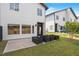 View of the modern home featuring a patio, garden boxes and grass at 2225 Millbank Village Ct # 101, Raleigh, NC 27610