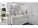 Modern bathroom featuring double vanity, sleek black fixtures, and a glass-enclosed shower at 2225 Millbank Village Ct # 101, Raleigh, NC 27610