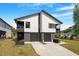 Modern two-story home with a dual garage, clean lines and manicured landscaping at 2225 Millbank Village Ct # 101, Raleigh, NC 27610