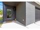Contemporary home's front entrance with sleek gray siding, modern door, and minimalist landscaping at 2225 Millbank Village Ct # 101, Raleigh, NC 27610