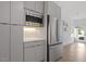 Efficient kitchen with stainless steel appliances, gray cabinets, and ample storage space with an adjacent door to the outside at 2225 Millbank Village Ct # 101, Raleigh, NC 27610