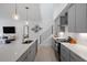 Modern kitchen with gray cabinets, stainless steel appliances, a center island, and an adjacent staircase at 2225 Millbank Village Ct # 101, Raleigh, NC 27610