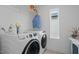 Modern laundry room equipped with front load washer and dryer and shelving at 2225 Millbank Village Ct # 101, Raleigh, NC 27610