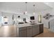 Open-concept kitchen and living area with stainless steel appliances, pendant lighting, and access to the exterior at 2225 Millbank Village Ct # 101, Raleigh, NC 27610