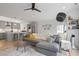 Open floor plan showcases a modern kitchen, a comfortable gray sofa and a ceiling fan at 2225 Millbank Village Ct # 101, Raleigh, NC 27610