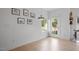 Bright living room featuring light hardwood flooring, white walls adorned with art, and natural light at 2225 Millbank Village Ct # 101, Raleigh, NC 27610