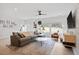 Spacious living room with a large sectional couch, ceiling fan, and sun-filled windows at 2225 Millbank Village Ct # 101, Raleigh, NC 27610