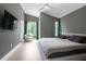 Large main bedroom boasts modern design, a ceiling fan, and features a private balcony at 2225 Millbank Village Ct # 101, Raleigh, NC 27610
