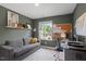 Comfortable office with a gray couch, a large window, and modern desk setup at 2225 Millbank Village Ct # 101, Raleigh, NC 27610