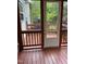 View of back porch with painted wood floor, white painted door and wood railing at 2305 Summit Dr, Hillsborough, NC 27278