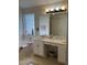 Bathroom with double sink vanity with tub encased by glass block window for natural light at 2305 Summit Dr, Hillsborough, NC 27278